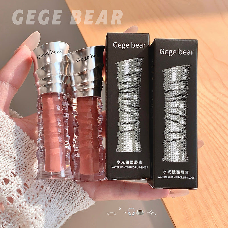 Three lip glosses and their packaging held by a hand, with 'Gege Bear' branding.