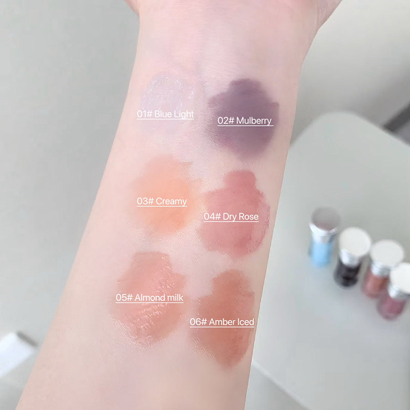 Lipstick swatches on a person's wrist with color names labeled