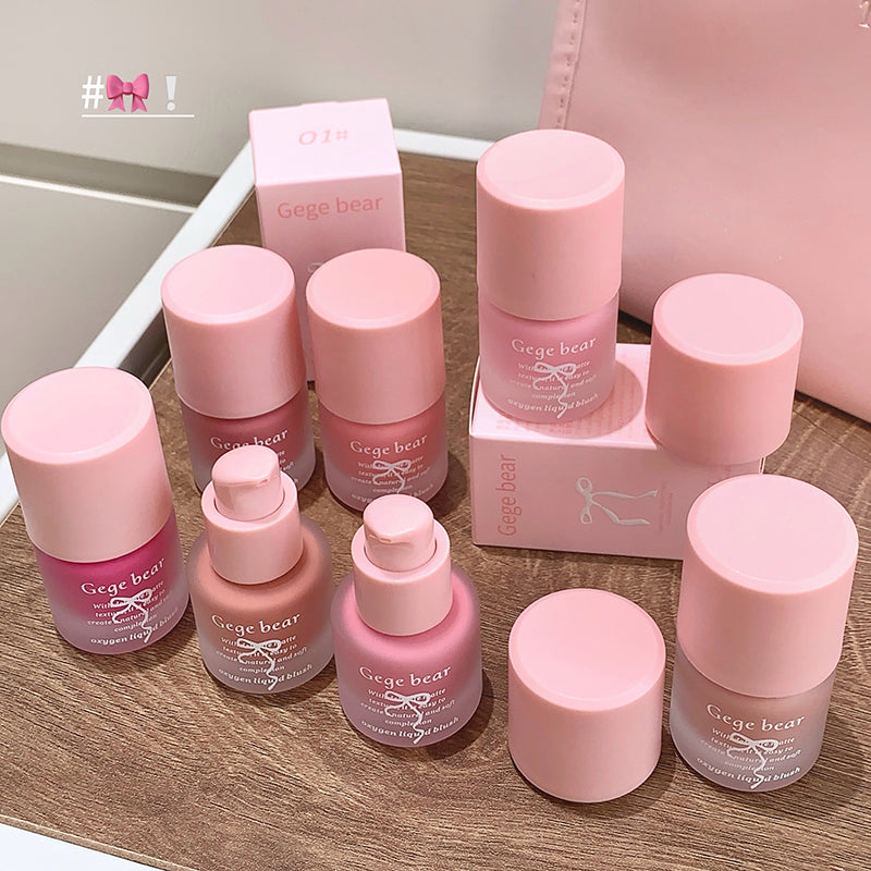 Collection of pink 'Gege bear' skincare products on a wooden surface.