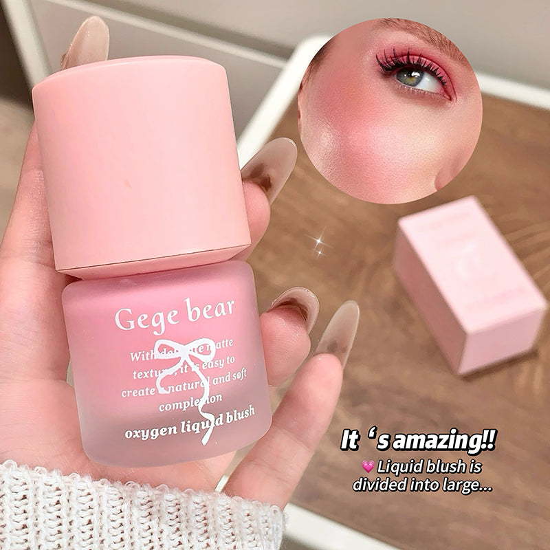 Pink liquid blush bottle held by a hand with an inset of a pink blush on skin.