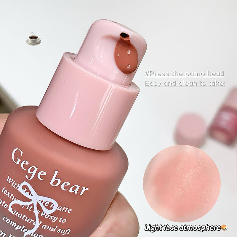 Pink bottle of Gege bear makeup product with pump head and color swatch on a blurred background