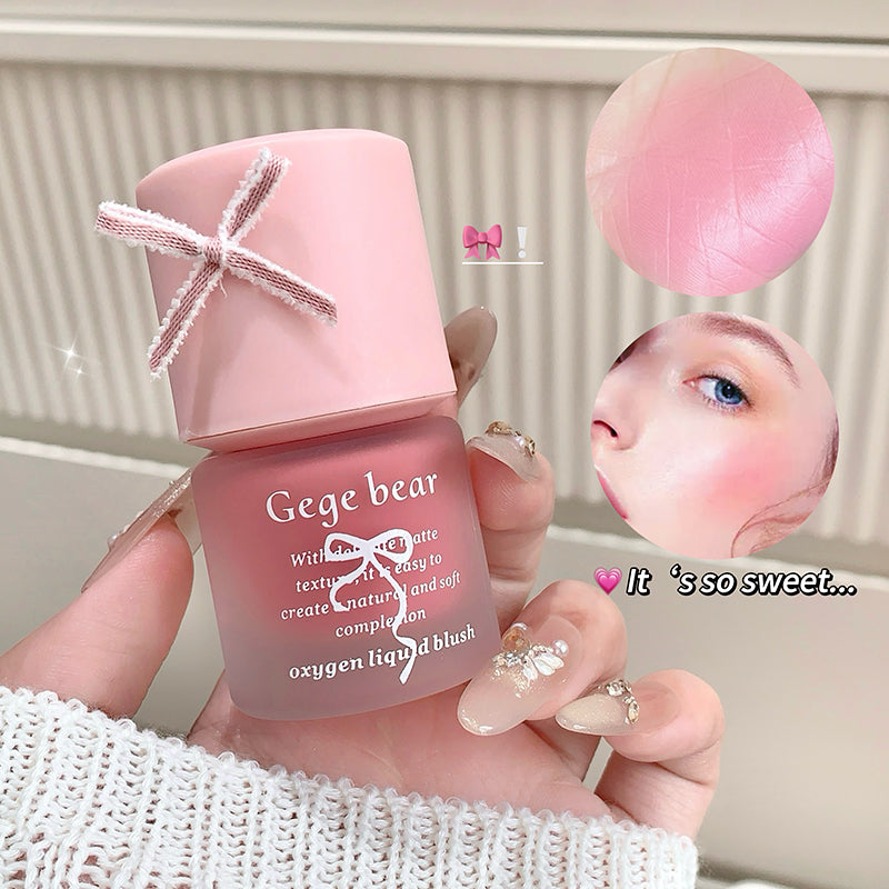 Pink Gege bear oxygen liquid blush held by a hand with a blurred background