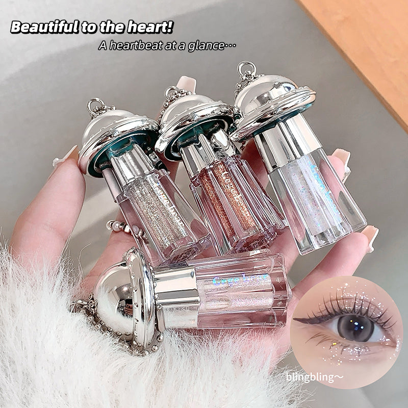 Decorative lip glosses with silver tops held by a hand, close-up of an eye with glitter applied.
