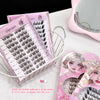 False eyelashes in pink packaging with visible adhesive strip on a white surface.
