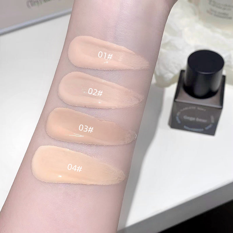 Four swatches of cosmetic product on a person's arm with labeled numbers, next to a bottle.