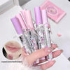Set of pink lip glosses with rabbit designs held by a hand on a light background.