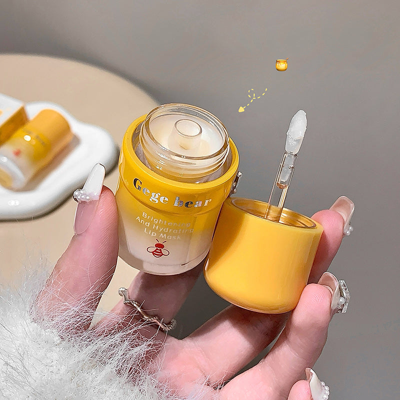 Hand holding a yellow skincare product with dropper and visible brand name.