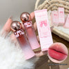 Two lip glosses with rose gold caps and a pink gradient, alongside their packaging and a close-up of lips wearing the product.