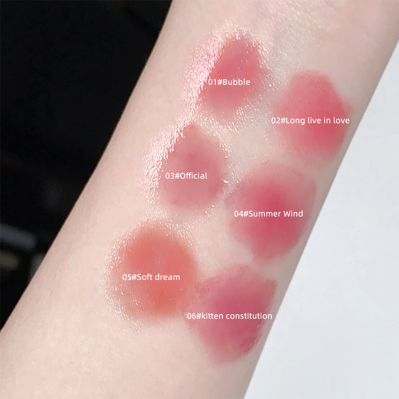 Lipstick swatches on a person's arm with color names labeled