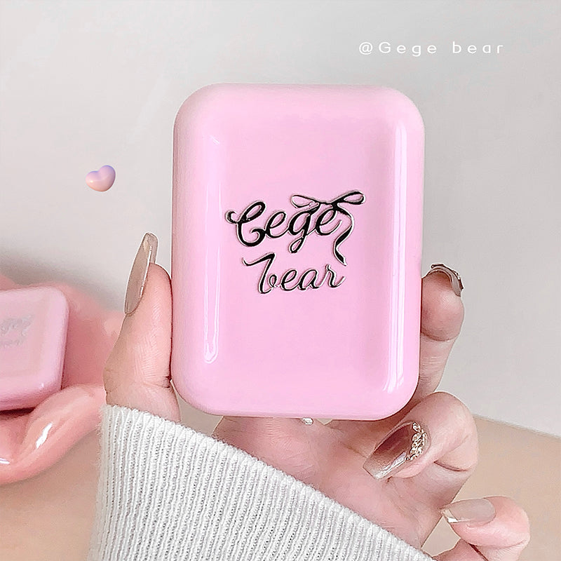 Pink electronic device with 'Gege bear' branding held by a hand against a light gray background.