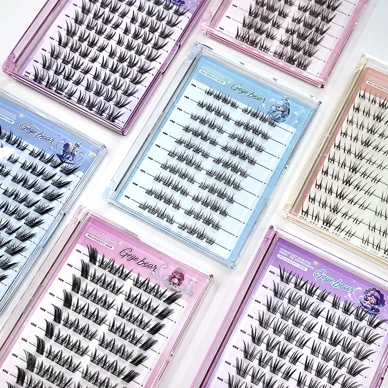 Multiple trays of false eyelashes with colorful packaging on a white background