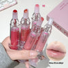 Set of lip glosses held by a hand with a close-up of glossy lips.