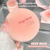 Gege bear air cushion compact held by a hand with blurred background