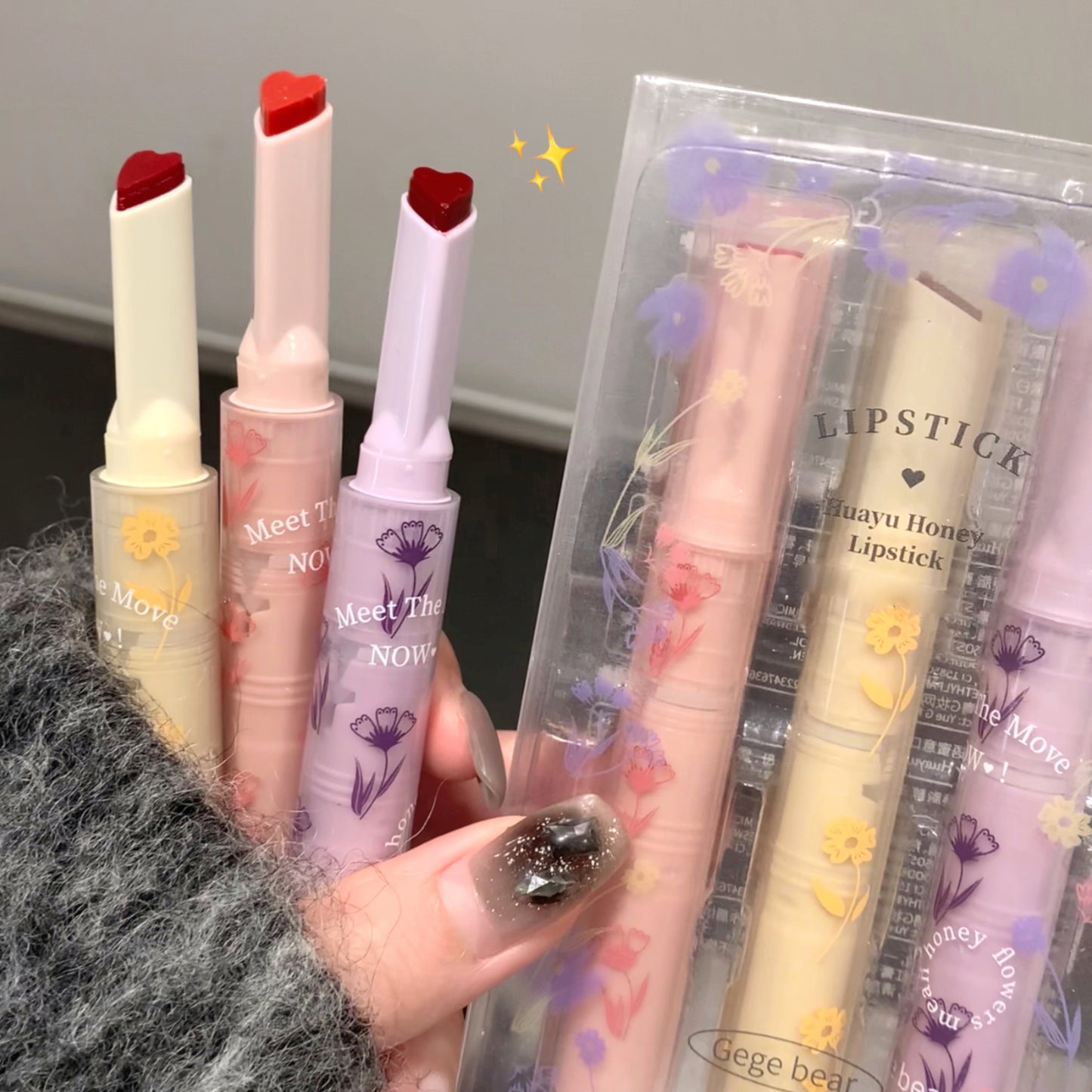 Set of lipsticks with visible branding and packaging details.