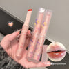 Two lipsticks with floral packaging held by a hand, with a close-up of lips wearing the lipstick on the side.