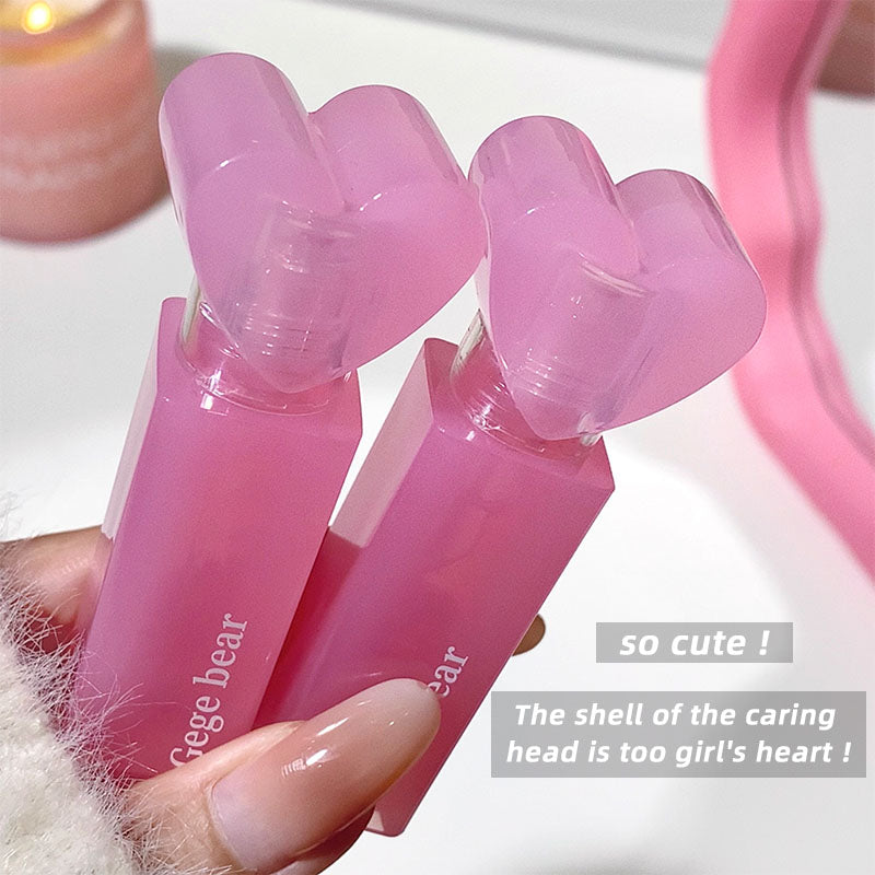 Pink heart-shaped product held by a hand with a soft focus background