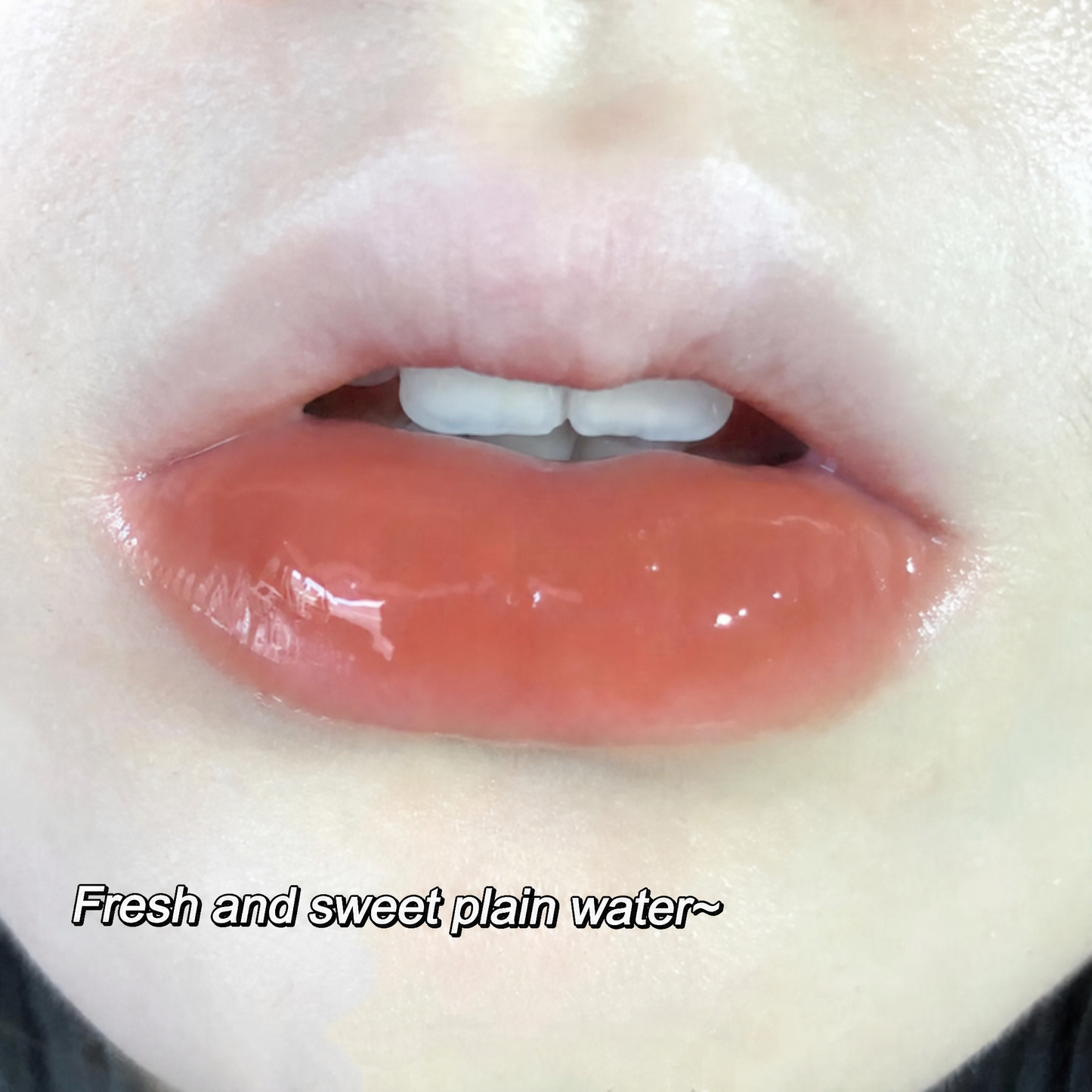 Close-up of glossy lips with text 'Fresh and sweet plain water~'
