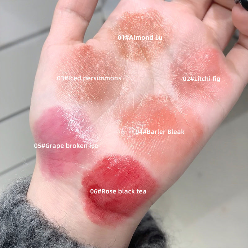 Color swatches on a person's wrist with labeled shades of lipstick.