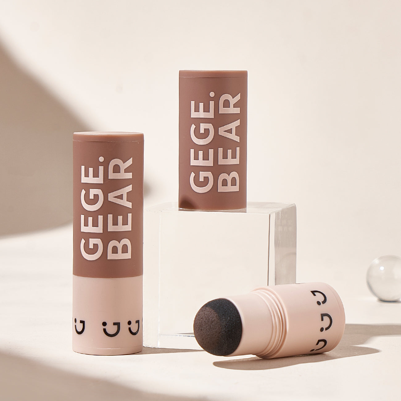Three cosmetic products with 'GEGE BEAR' branding on a neutral background
