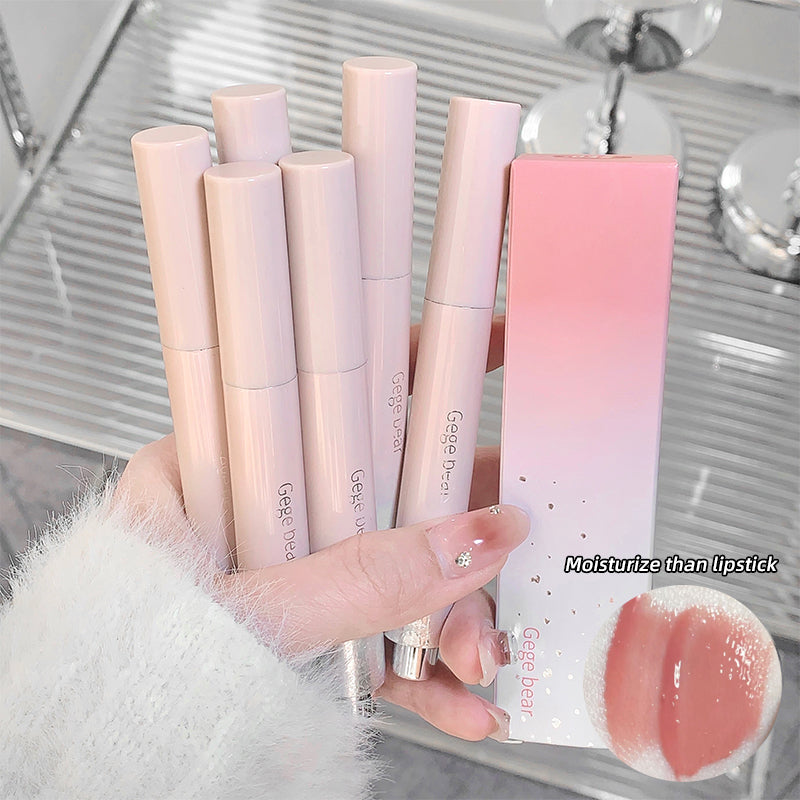 Set of lip products including lipsticks and a gloss with a hand holding them.