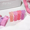 Set of Gege Bear lip glosses in various shades on a white background