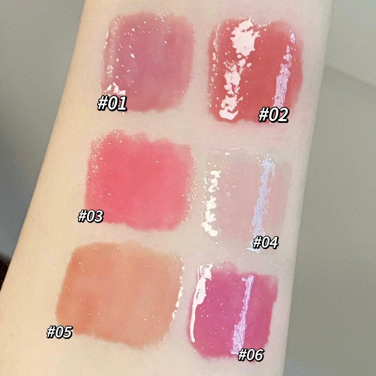 Lipstick swatches on a arm with labeled colors