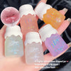 Set of lip gloss bottles with colorful caps held in a hand.