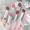 Set of lipsticks held by a hand with a blurred background