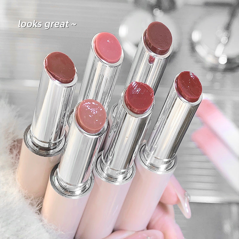 Set of lipsticks held by a hand with a blurred background