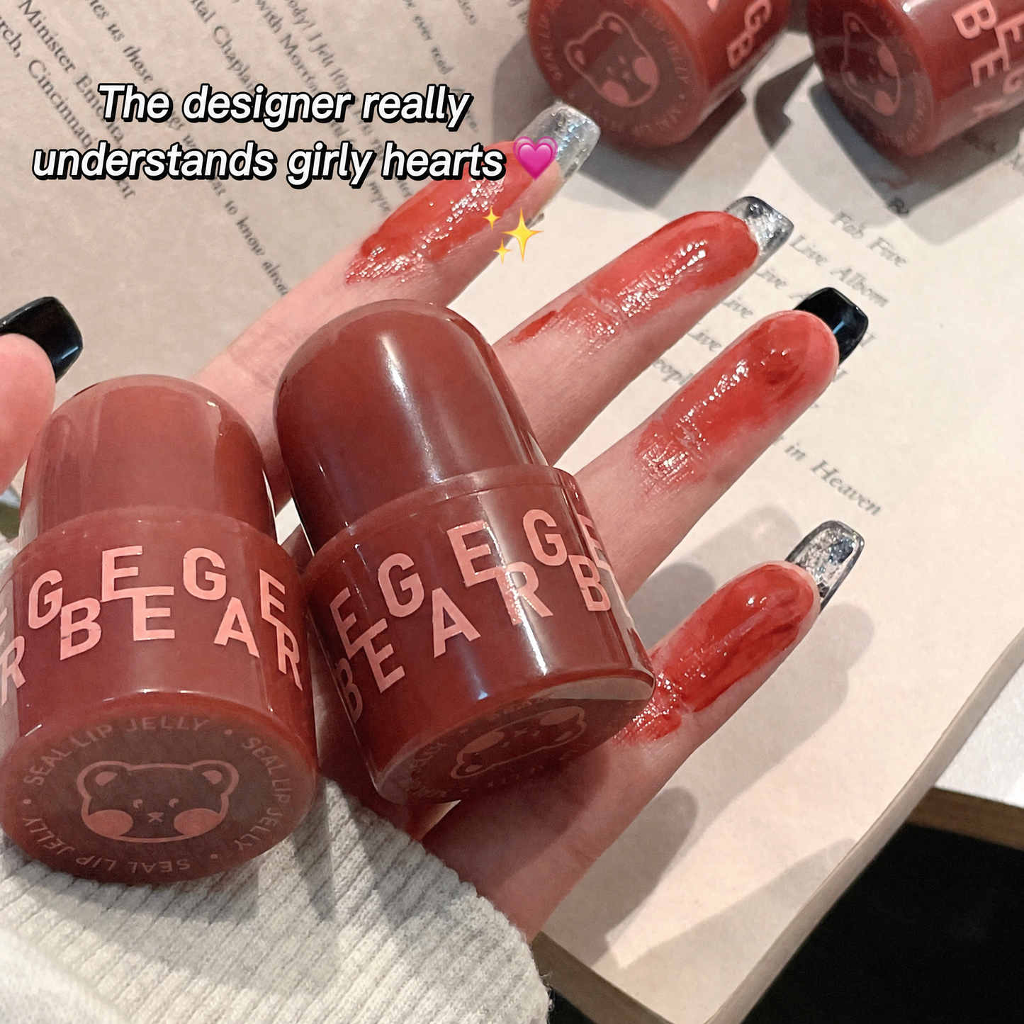 Hand holding GEGER BEAR lip products with text overlay