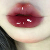 Close-up of glossy lips with a neutral background