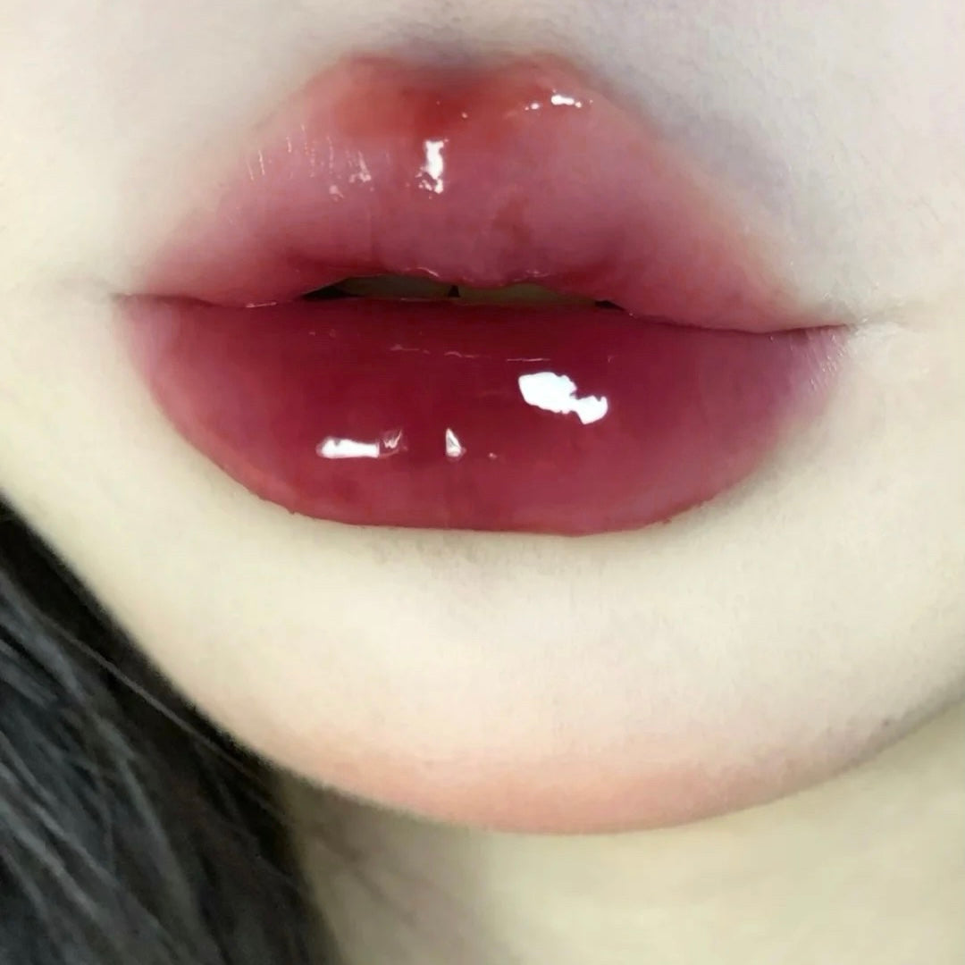 Close-up of glossy lips with a neutral background