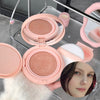 Pink compact powder with a mirror and a blurred face in the background