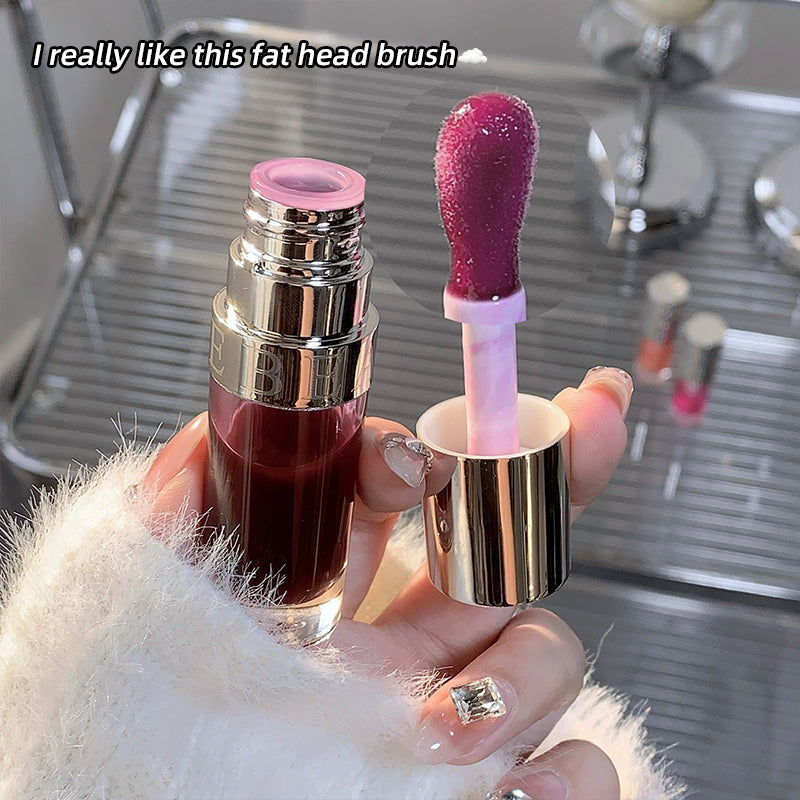 Lipstick with a unique fat head design held by a person, with text 'I really like this fat head brush'.