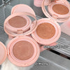 Pink makeup compacts with different shades on a metallic surface