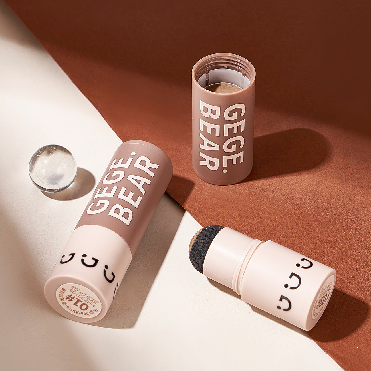 Makeup stick with 'GEGE BEAR' branding on a brown and white background