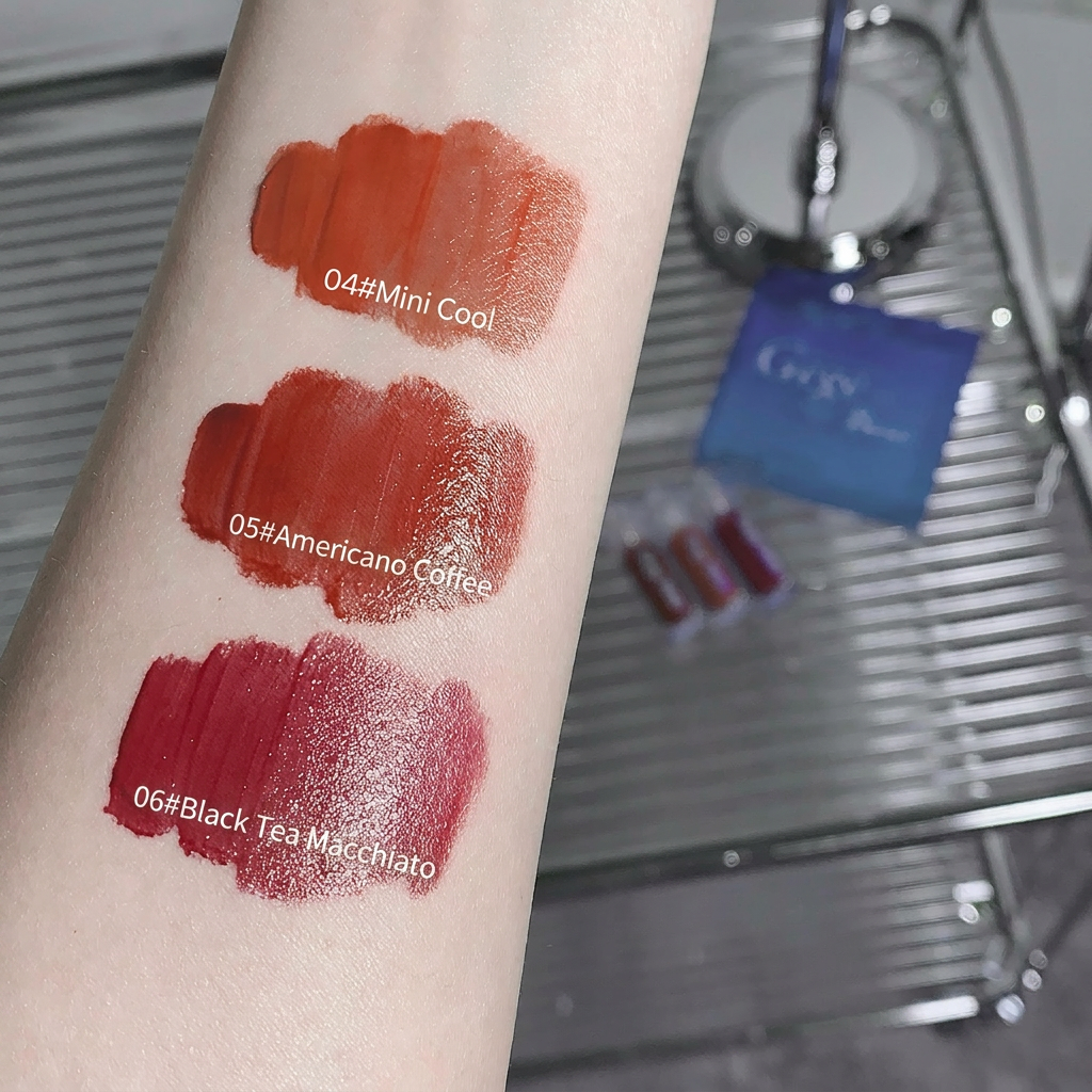 Lipstick swatches on a person's arm with product names and codes, against a blurred background.