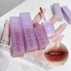 Purple lip gloss with 'GEGE' branding on a white background, showing a close-up of lips wearing the gloss.