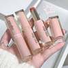 Four lipsticks from the brand 'Gege bear' held in a hand against a light background.