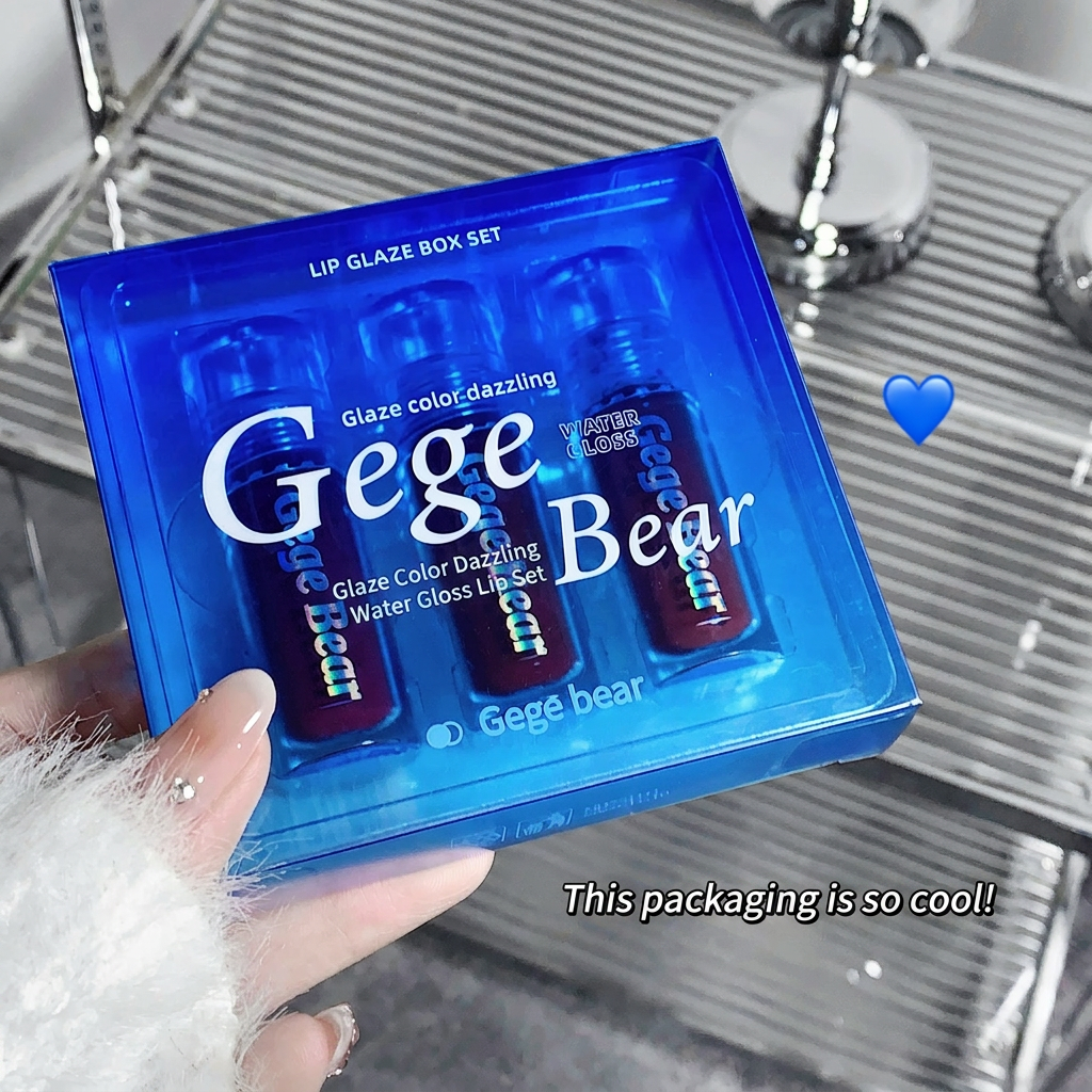 Gege Bear lip gloss set in blue packaging held by a hand with a heart emoji and text.