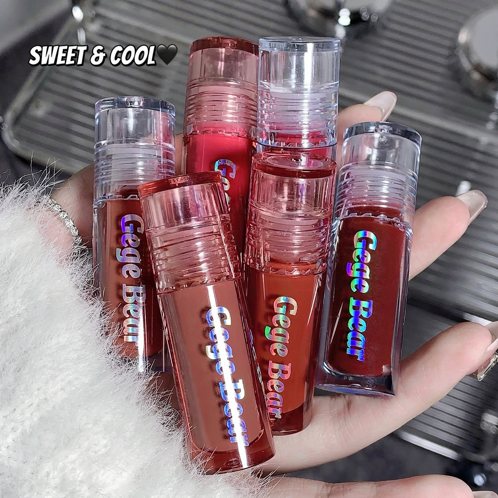 Hand holding multiple lip glosses with 'Gege Bear' branding against a blurred background.
